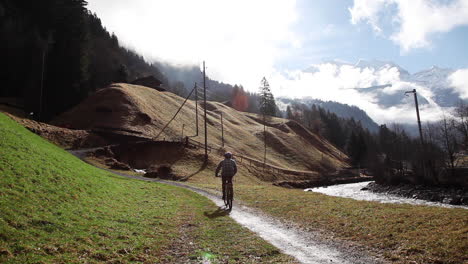 Cyclist-going-downhill-peak-Lauterbrunnen-Switzerland