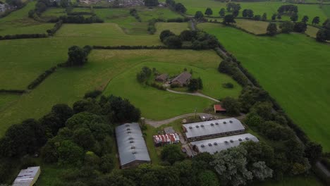 Aerial-shot-of-British-farm-house-in-green-countryside