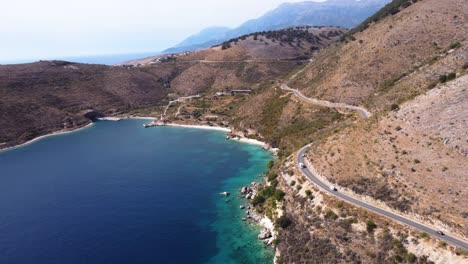 AERIAL-Fly-By-over-a-Coastal-Highway-in-Albanian-Riviera
