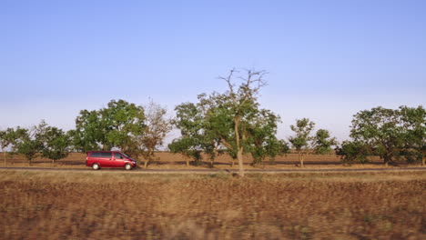 Wide-shot-of-taking-a-peaceful-drive-down-a-country-road-lined-with-trees