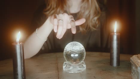 Woman-is-spinning-around-a-crystal-ball,-mystical-and-esoteric-atmosphere