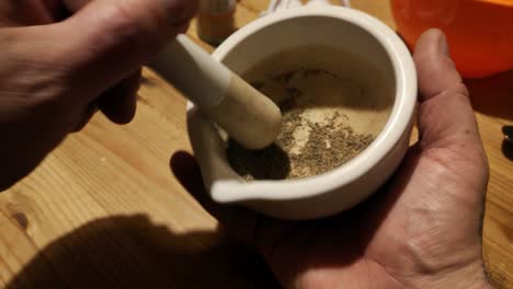 Grinding-black-pepper-powder-herbal-remedy-supplement-with-mortar-and-pestle