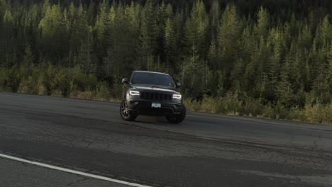 Drone-shoot-of-a-Grey-Jeep-Cherokee-in-4K-in-a-Mountain-Road