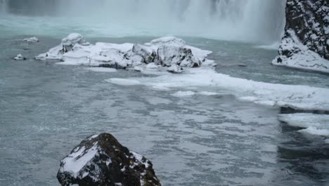 View-of-the-Godafoss-Waterfall-in-Skjalfandafljot-River-during-Winter-in-North-Iceland---tilt-down-shot