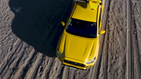 Overhead-view-of-oceanside-lifeguards-driving-down-beach,-oceanside-harbor