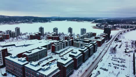 Aerial-view-overlooking-apartments-and-condos-in-Lutakko,-Jyvaskyla,-winter-evening-in-Finland---tracking,-drone-shot