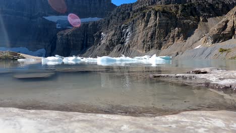 Time-Lapse-of-the-icebergs-at-Grinnell-Glacier-floating-and-shifting-in-the-wind-on-a-warm-sunny-afternoon-at-the-end-of-the-2022-season