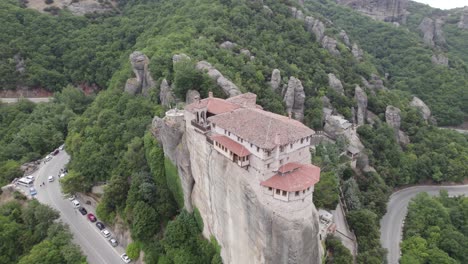 Aerial-view-of-Monastery-of-Rousanou-on-top-of-the-rock,-building-on-edge-of-a-cliff,-orbiting