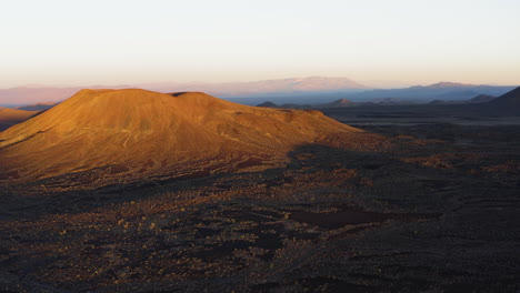 Drone-approaching-Cima-Volcanic-Field-cinder-cones-craters-in-San-Bernardino-County,-California