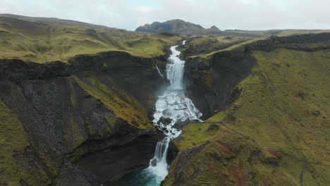 Aerial-parallax-around-Ofaerufoss-Waterfall-flowing-through-Iceland-Highlands