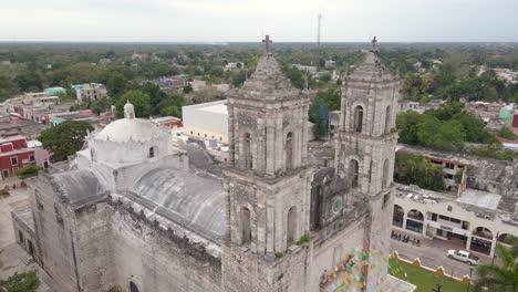 Close-orbital-drone-shot-of-the-famous-Iglesia-de-San-Servacio-church-with-the-city-also-in-view
