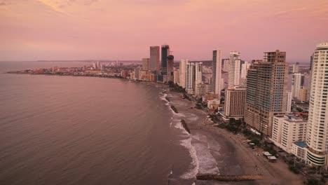An-aerial-shot-of-the-sun-setting-on-the-skyline-of-Cartagena,-Colombia