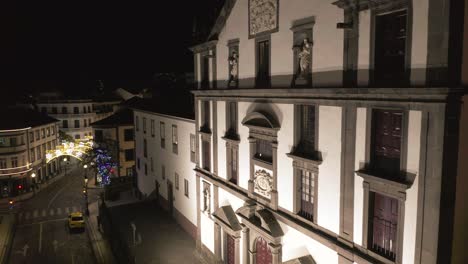 Church-of-Saint-John-the-Evangelist-of-the-College-of-Funchal-in-city-center-at-night,-aerial