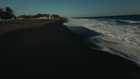 Drone-Flying-On-Foamy-Waves-At-The-Black-Sand-Coastline-Of-Monterrico-Beach-In-Guatemala