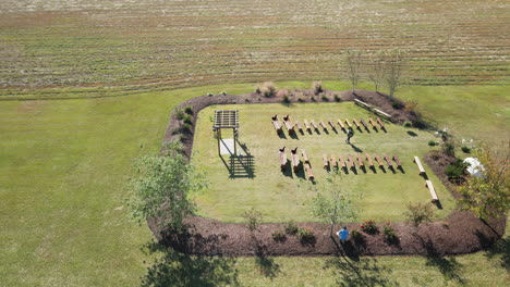 Wedding-ceremony-before-people-arrive-set-up-on-farm-property-aerial