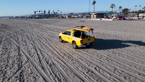Closeup-of-oceanside-lifeguards-driving-down-the-beach-at-oceanside-harbor