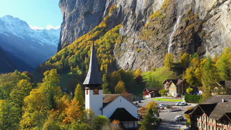 Rotating-drone-shot-of-the-Staubbach-waterfall-church-in-Lauterbrunnen-Bernese-Oberland-Switzerland