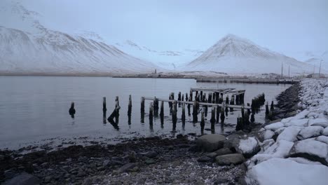 Quiet-Space-In-Siglufjordur-with-an-Old-Broken-Pier-By-The-Shore---monochrome-shot