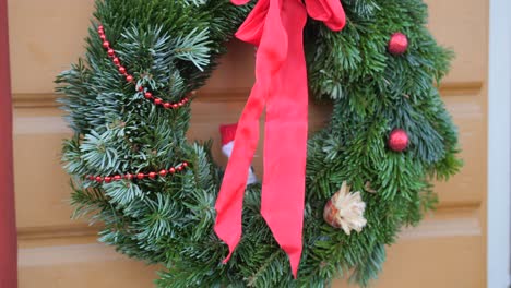 Christmas-Wreath-With-Red-Ribbon-On-A-House-Door