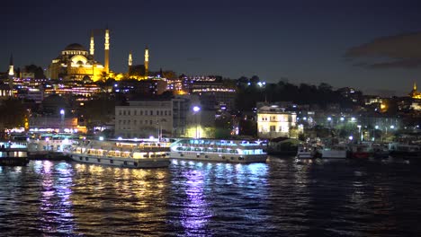 Panoramic-Cityscape-View-of-Bosporus-and-Illuminated-Mosque-in-Istanbul-at-Night
