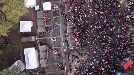 Descending-aerial-top-down-shot-Chacarera-folk-dance-on-stage-in-street-of-Buenos-Aires---People-celebrating-show-outdoors