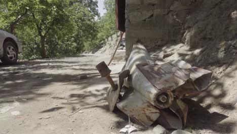 Unexploded-powerful-rocket-with-hand-grenade-on-side,-Pashir-valley,-Afghanistan