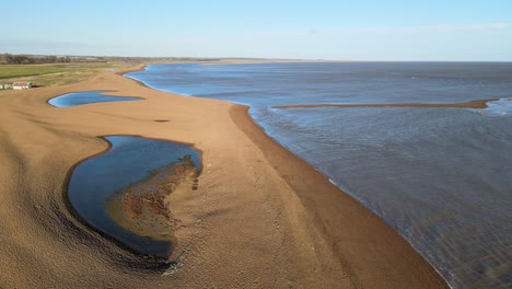 Aerial-image-shingle-street-,-beach-Suffolk-lone-remote-cottage-reveal-shot-bright-sunny-day