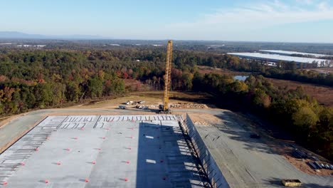 A-drone-elevator-shot-of-a-heavy-duty-crane-lifting-concrete-panels-into-place