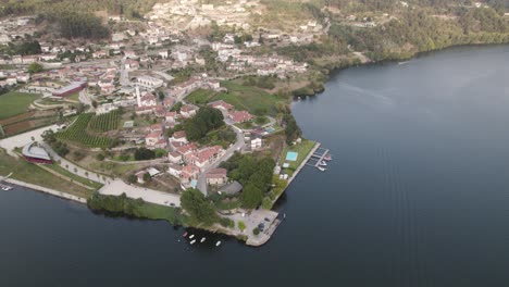 Aerial-top-down-view-small-village-riverfront,-Tâmega-and-Douro-river-intersection,-Entre-os-rios