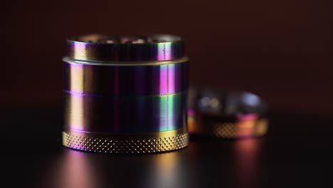 A-single-cannabis-grinder-with-colourful-reflections-on-the-table