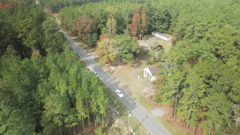 Derelict-cabin-in-woods-by-roadside-Orbiting-aerial