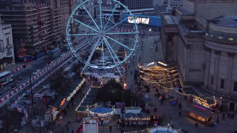 Liverpool-city-Christmas-market-Ferris-wheel-in-St-Georges-square-aerial-view-pan-right