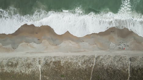 Top-down-aerial-from-shoreline-to-breaking-waves-and-foam-Wrightsville-Beach