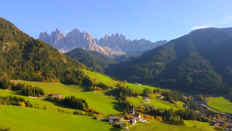 Wide-drone-footage-of-Chiesa-di-Santa-Maddalena-church-in-Italian-Dolomites-in-European-Alps