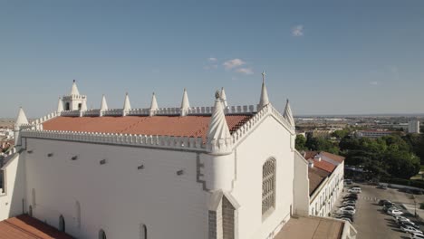 Aerial-orbiting-over-São-Francisco-Church-ornamented-Rooftop,-Evora