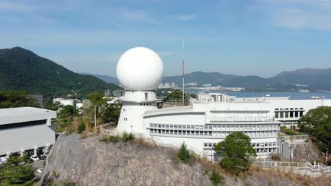 Chinese-University-of-Hong-Kong-radar-dome-overlooking-Hong-Kong-bay,-Aerial-view