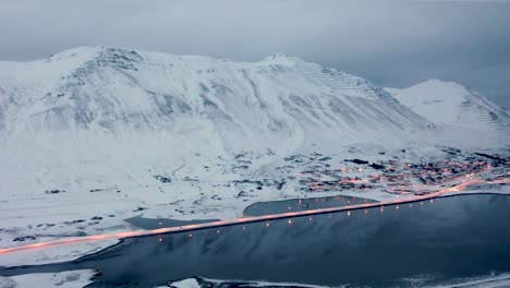 Aerial-panning-shot-of-avalanche-protection-and-snow-fences-in-snowy-mountains-above-Siglufjordur-City-in-Iceland