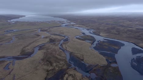 Hrutafjardara-river-delta-flowing-into-Hunafloi-bay-ending-in-Arctic-ocean-during-cloudy-day-in-Iceland---Aerial-forward-shot