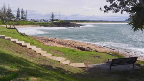 South-West-Rocks-Beach-During-Summer---Bench-Under-The-Shade-Of-Tree-With-Ocean-View---New-South-Wales,-Australia