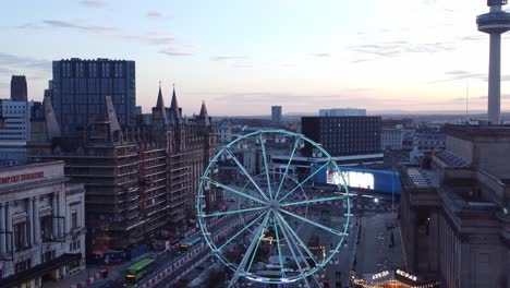 Liverpool-city-Christmas-market-sunset-skyline-and-radio-city-landmark-aerial-view-tilt-down-to-Ferris-wheel-attraction