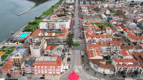 Aerial-view-of-the-beautiful-city-of-Aveiro,-Portugal,-with-its-famous-lighthouse-in-the-foreground