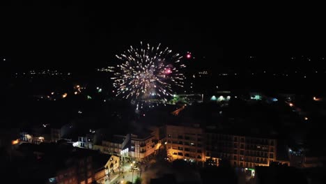New-Year-Celebration,-Aerial-View-of-Magical-Fireworks-Above-Cityscape,-Drone-Shot