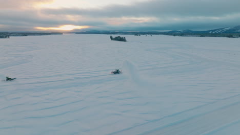Norbotten-tractor-snow-blower-preparing-vast-ice-driving-track-aerial-orbiting-view