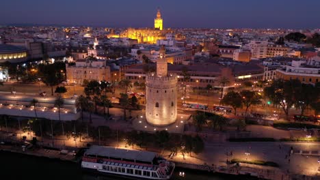 Night-orbital-view-of-Torre-del-Oro-or-Golden-Tower-watchtower-in-Seville-Spain