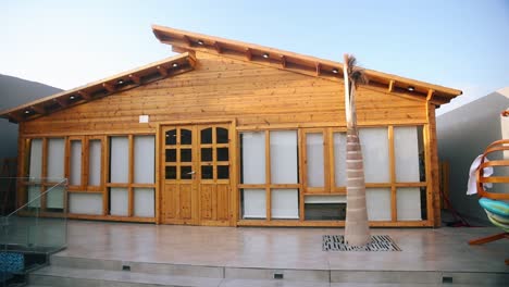 Close-up-pan-right-shot-of-newly-built-wooden-house-facade-at-golden-hour
