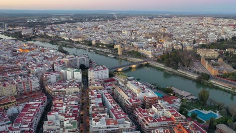 Aerial-view-of-Seville-spanish-capital-city,-Spain-cityscape-drone-shot-with-the-Guadalquivir-river-in-Andalusia