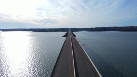 Drone-flyover-of-bridge-leading-into-Paris-Landing-State-Park-in-Paris-Tennessee