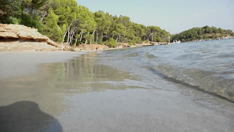 Sand-Beach-with-little-Waves-and-People-in-the-backround-at-Platja-de-Formentor-Mallorca-island-Palms