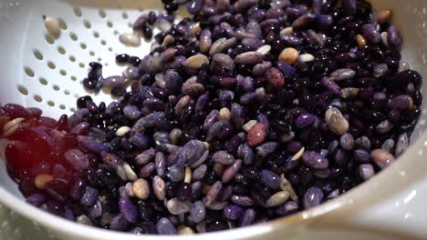 Closeup-Detail-of-Wet-Purple-Black-Beans-in-White-Colander