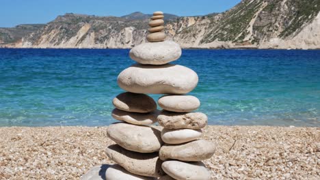 Stones-pebbles-stacks-on-beach-coast-in-Agia-Kiriaki,-Milos-island,-Greece---Concept-of-balance-and-harmony---close-up,-static
